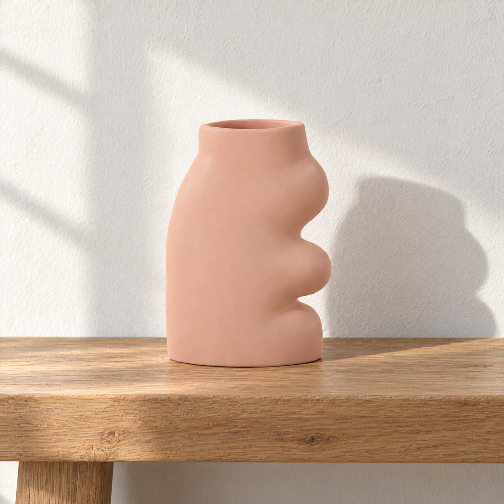 Fluxo large pink ceramic vase, empty, on an oak bench against a white limewash wall in morning sun