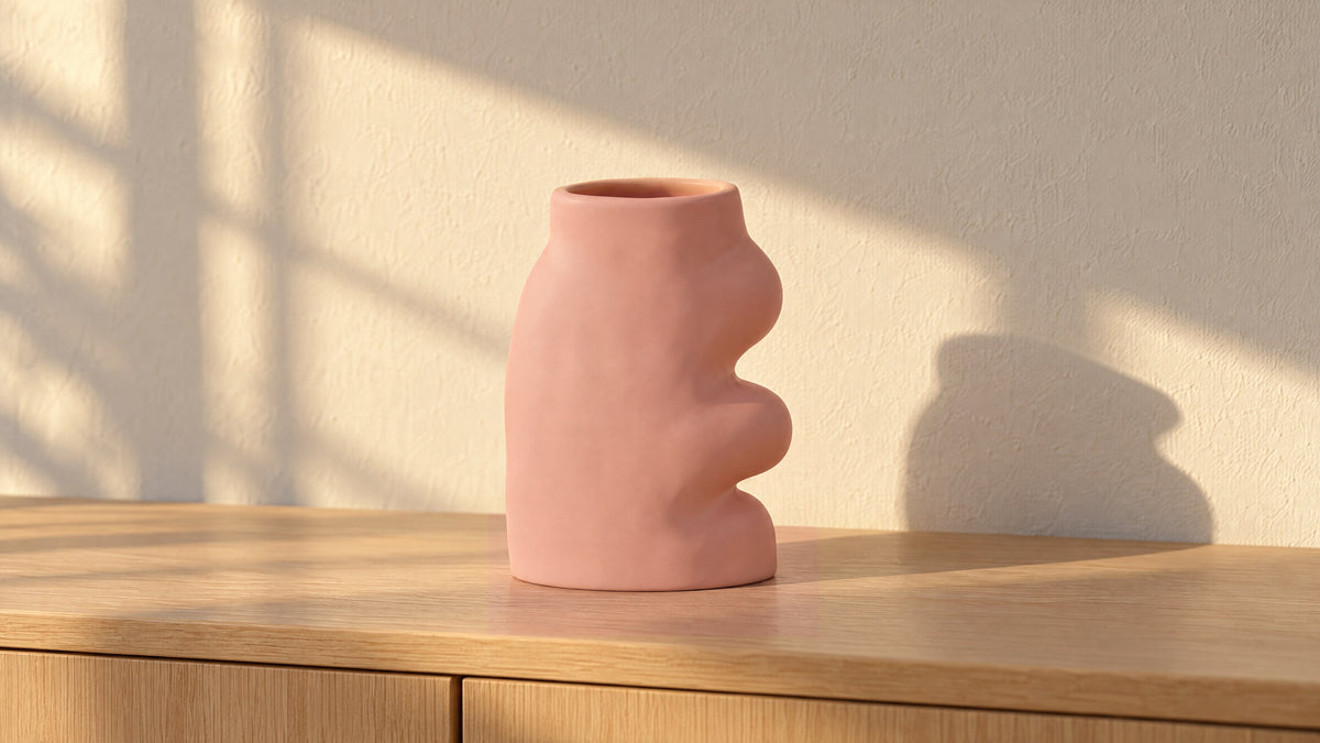 Fluxo large pink ceramic vase, empty, on a white oak sideboard in golden late-afternoon sun