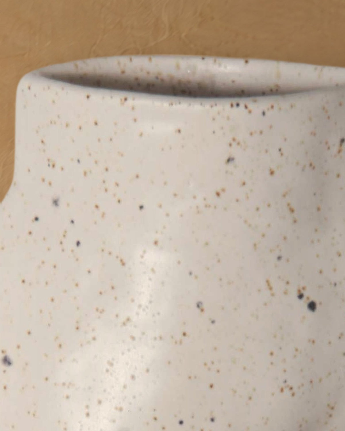 Close-up of the rounded rim and speckled white glaze of the Fluxo large white vase