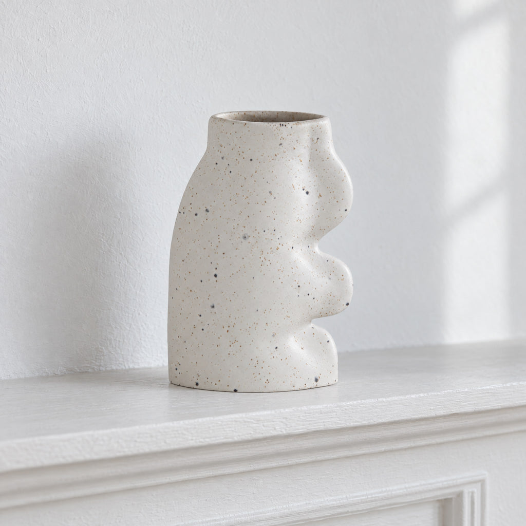 Fluxo large white speckled ceramic vase, empty, on a white painted mantel shelf