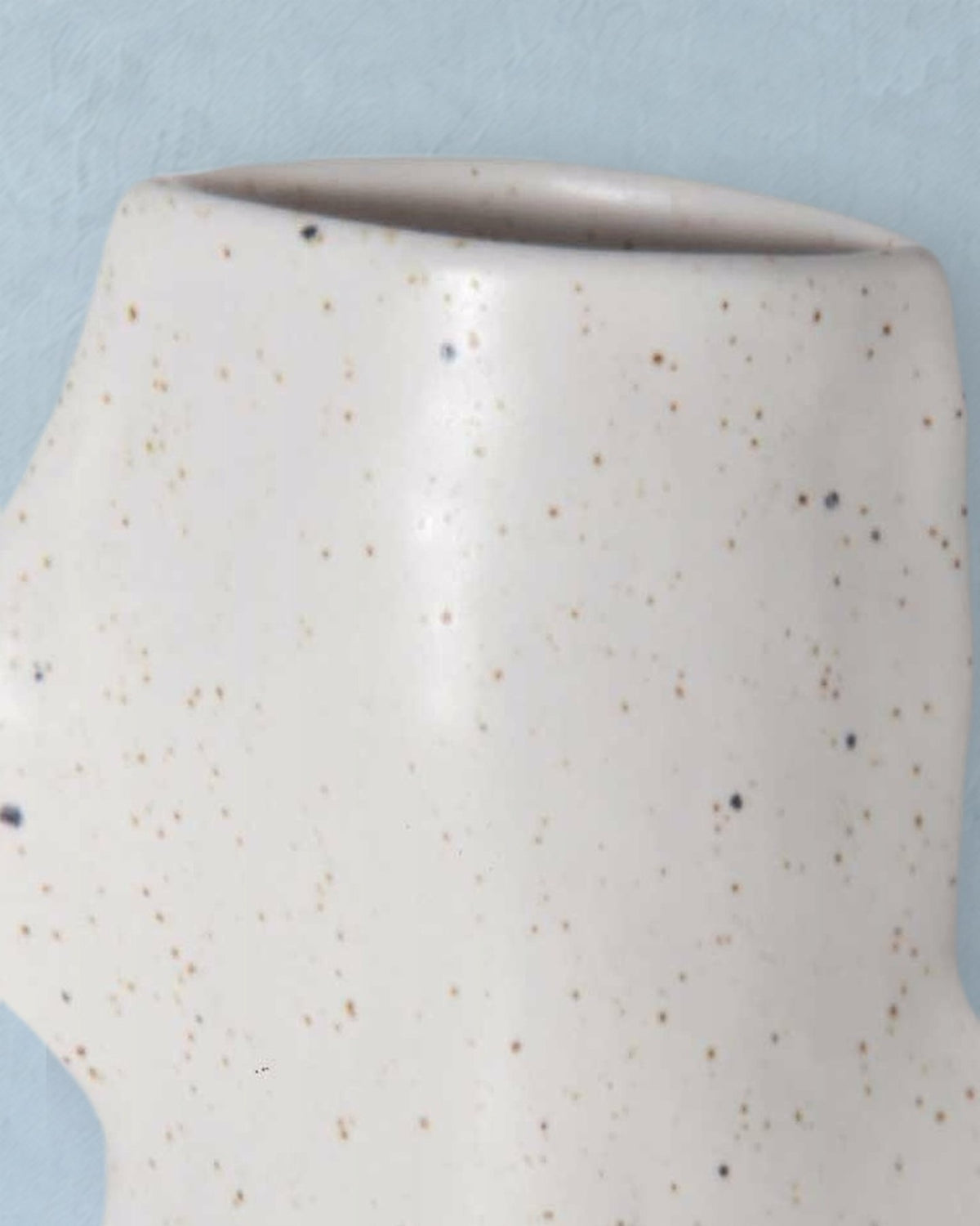 Close-up of the rim and speckled white glaze of the Fluxo medium white vase