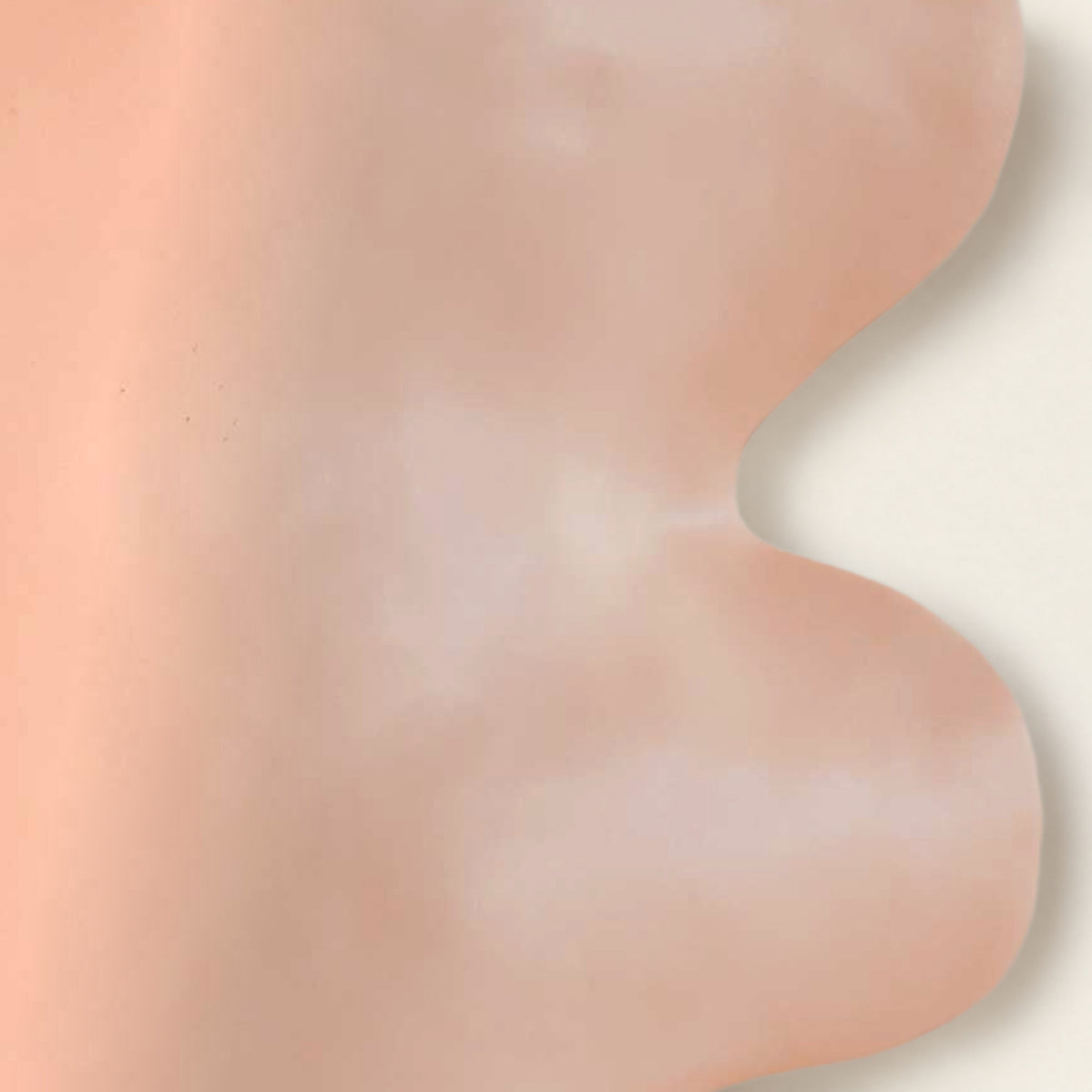 Close-up of the Fluxo pink vase: smooth matte pink glaze and wavy curve