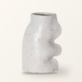 Fluxo large ceramic vase in white with a wavy side, on a plain warm-white backdrop