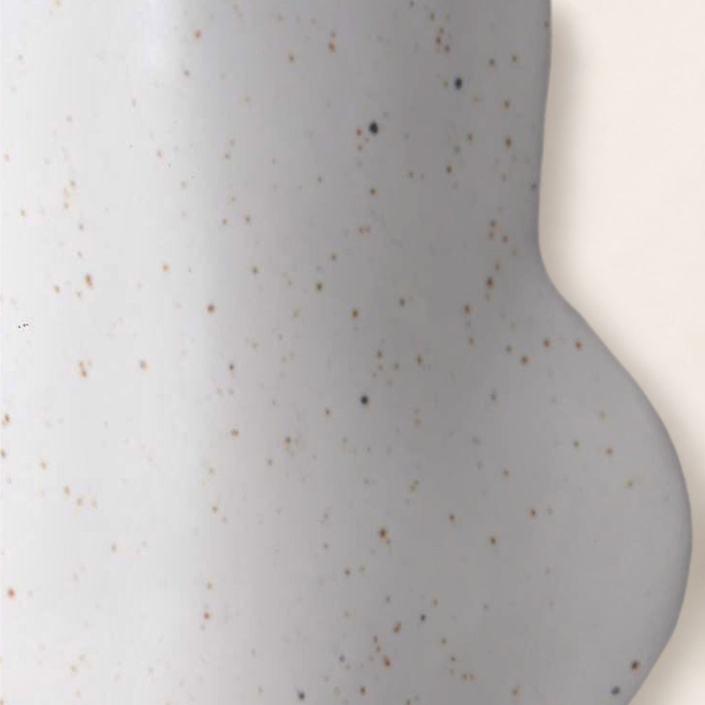 Close-up of the Fluxo white vase: matte white glaze with fine speckles