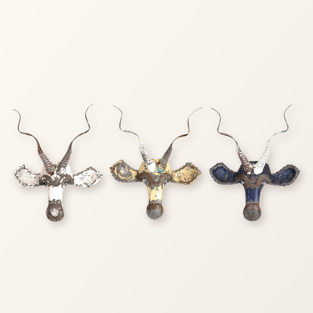 Three Kudu masks in white, cream and blue showing how colour varies from piece to piece; you receive one mask