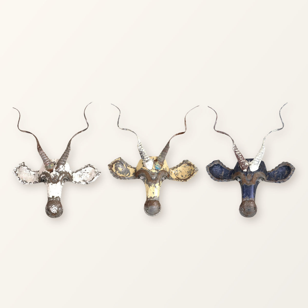 Three Kudu masks in white, cream and blue showing how colour varies from piece to piece; you receive one mask
