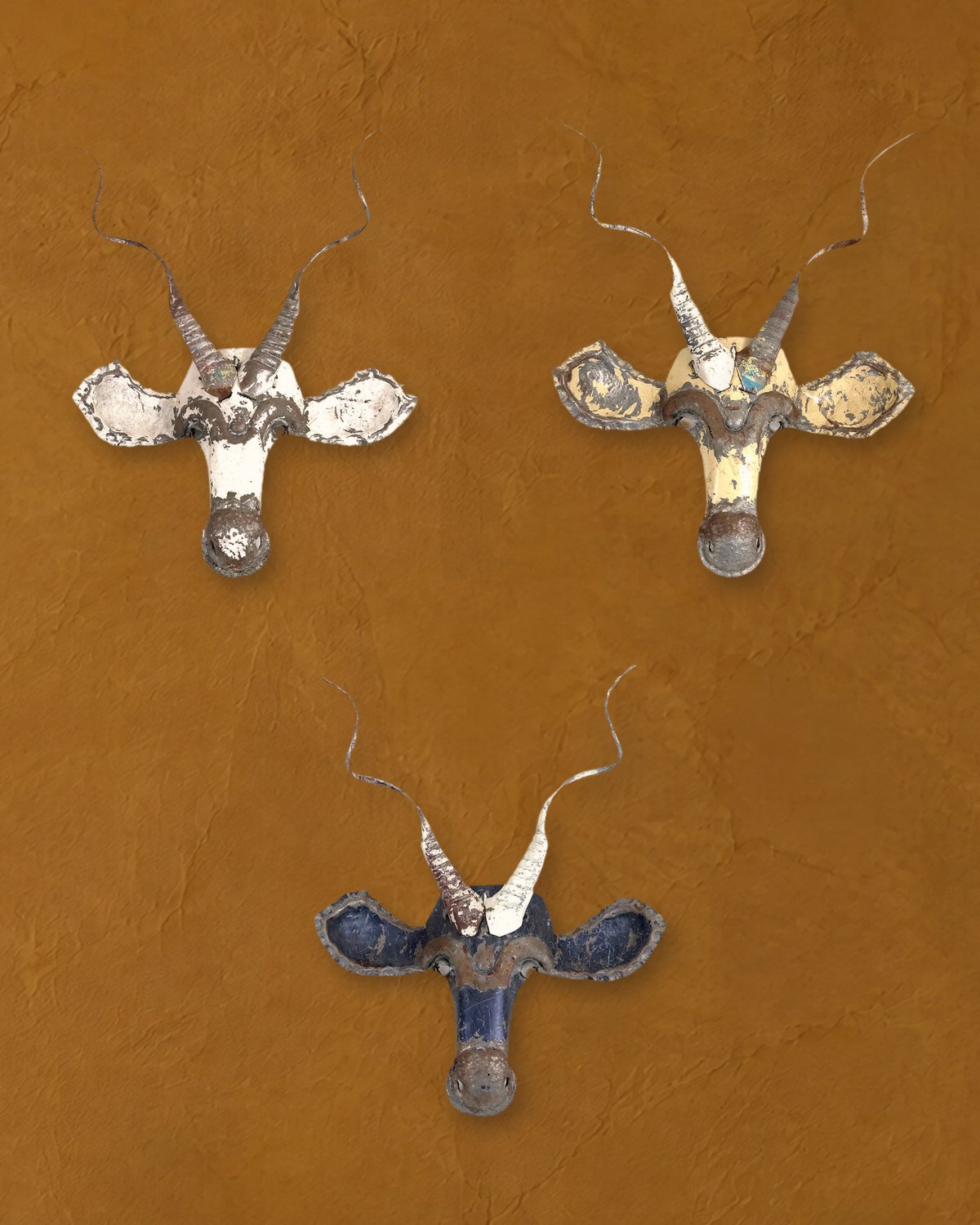 Three different Kudu masks in white, cream and blue, showing how color varies from piece to piece
