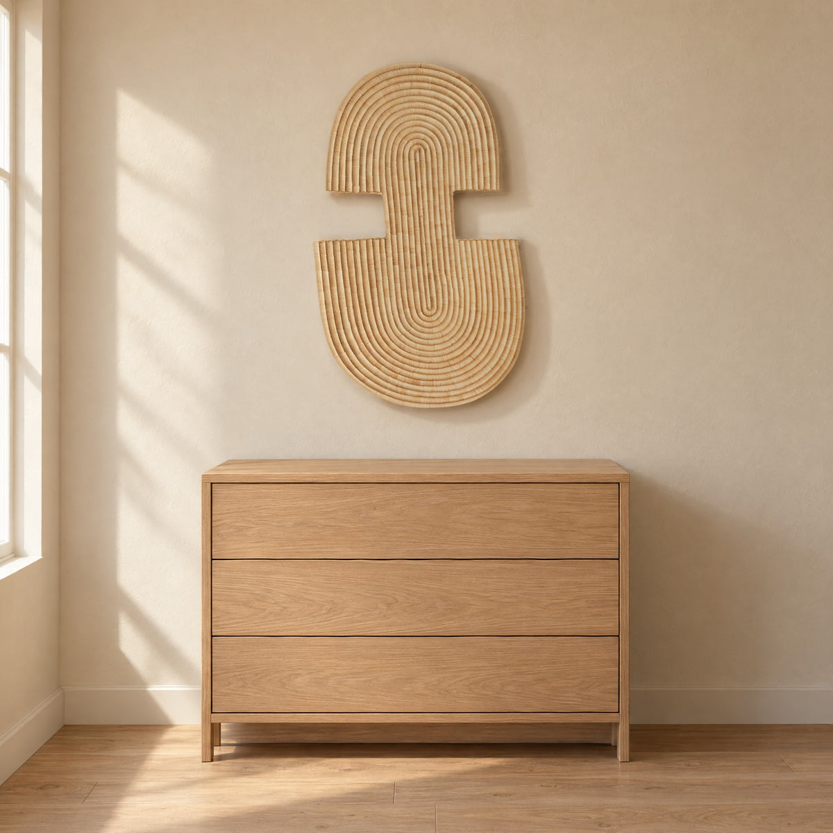 Abstract Wall Mask 2 hung on a warm beige plaster wall above an oak chest of drawers