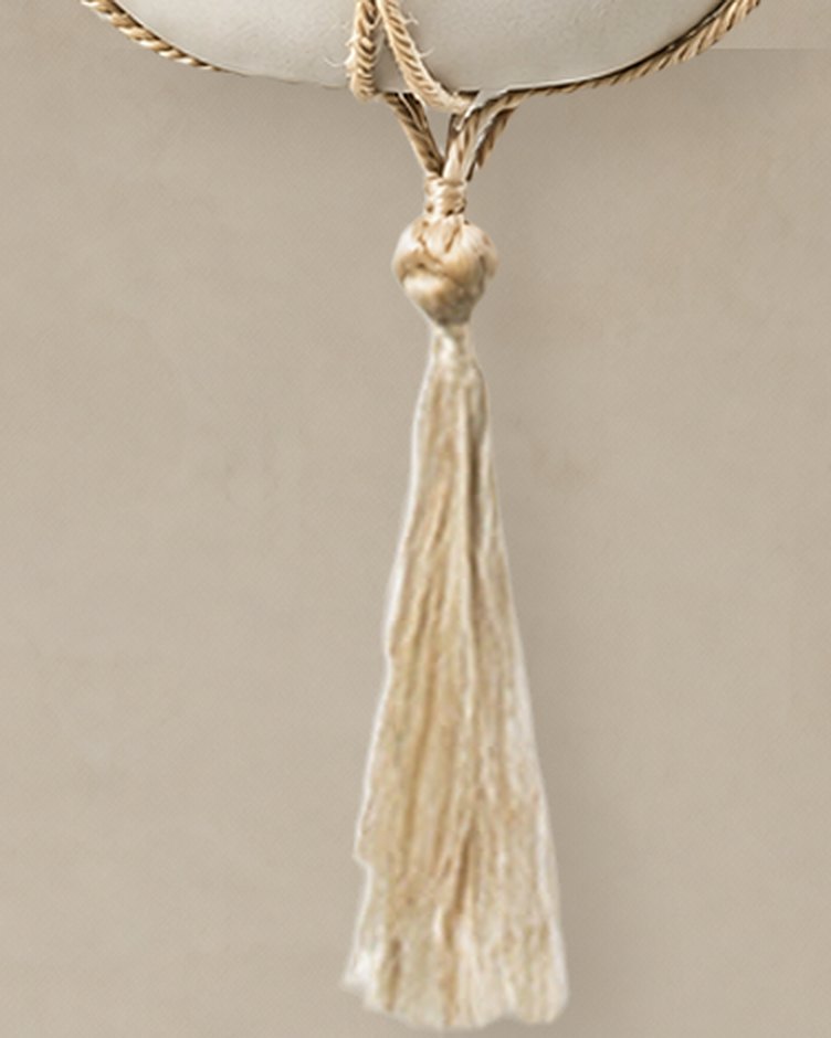 Close-up of the Nadu hanger’s knotted base and long jute tassel
