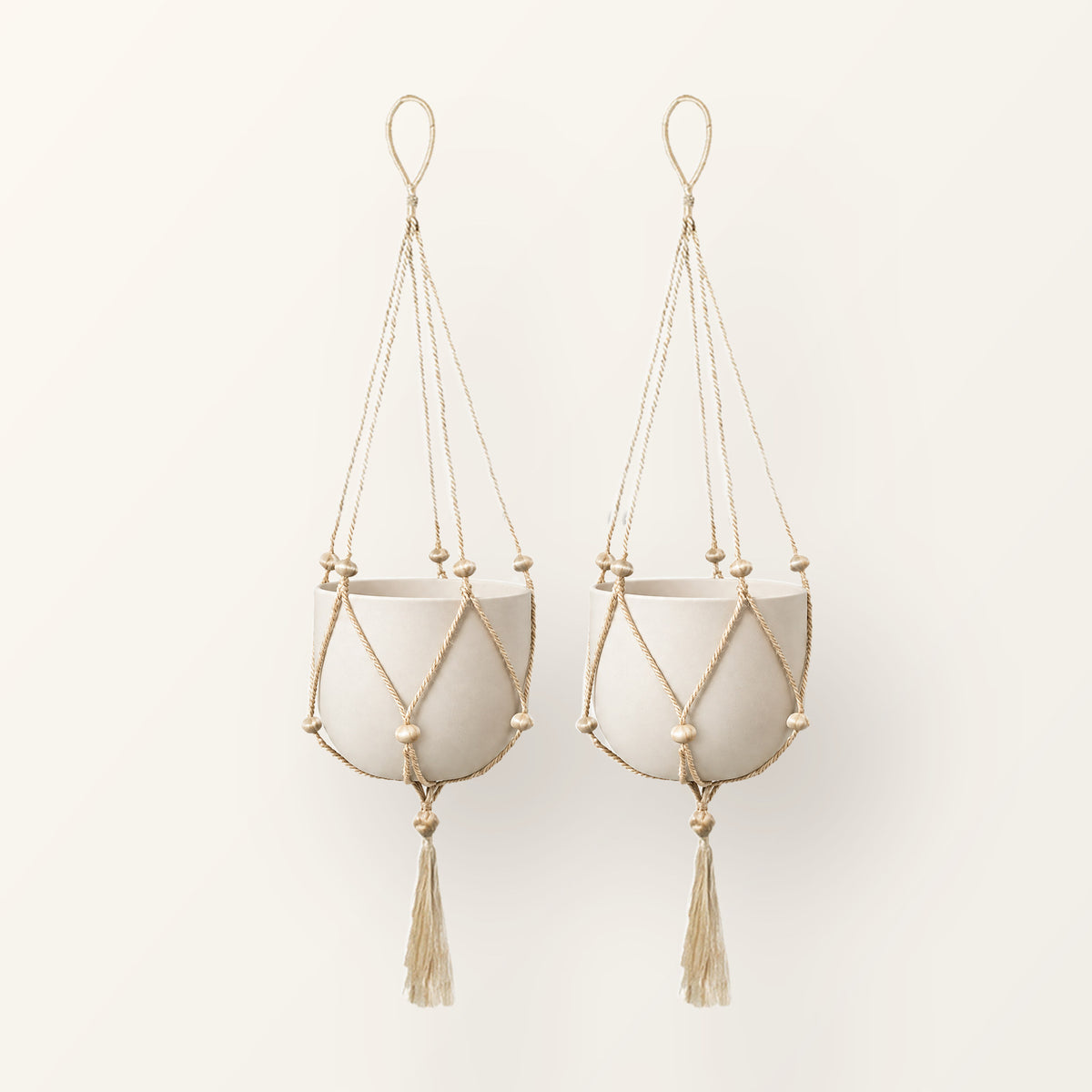 Nadu set of 2 jute macrame plant hangers with wooden beads, shown with plain pots (not included)
