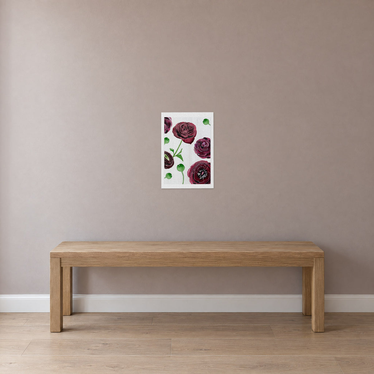 Unframed Black Ranunculus on Snow print, 13 x 19 in size, on a dusty-rose wall above a plain oak bench