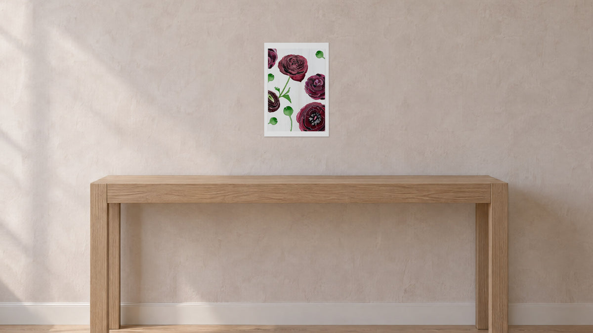 Unframed Black Ranunculus on Snow art print, 13 x 19 in size, on a blush-grey plaster wall above an oak console