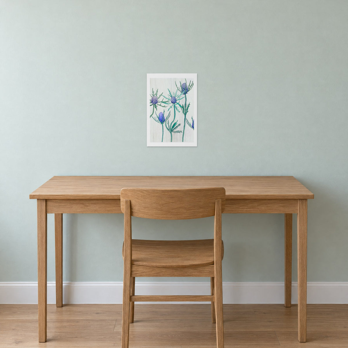 Unframed Purple Thistle on Snow print, 13 x 19 in size, on a mint-grey wall above a plain oak desk