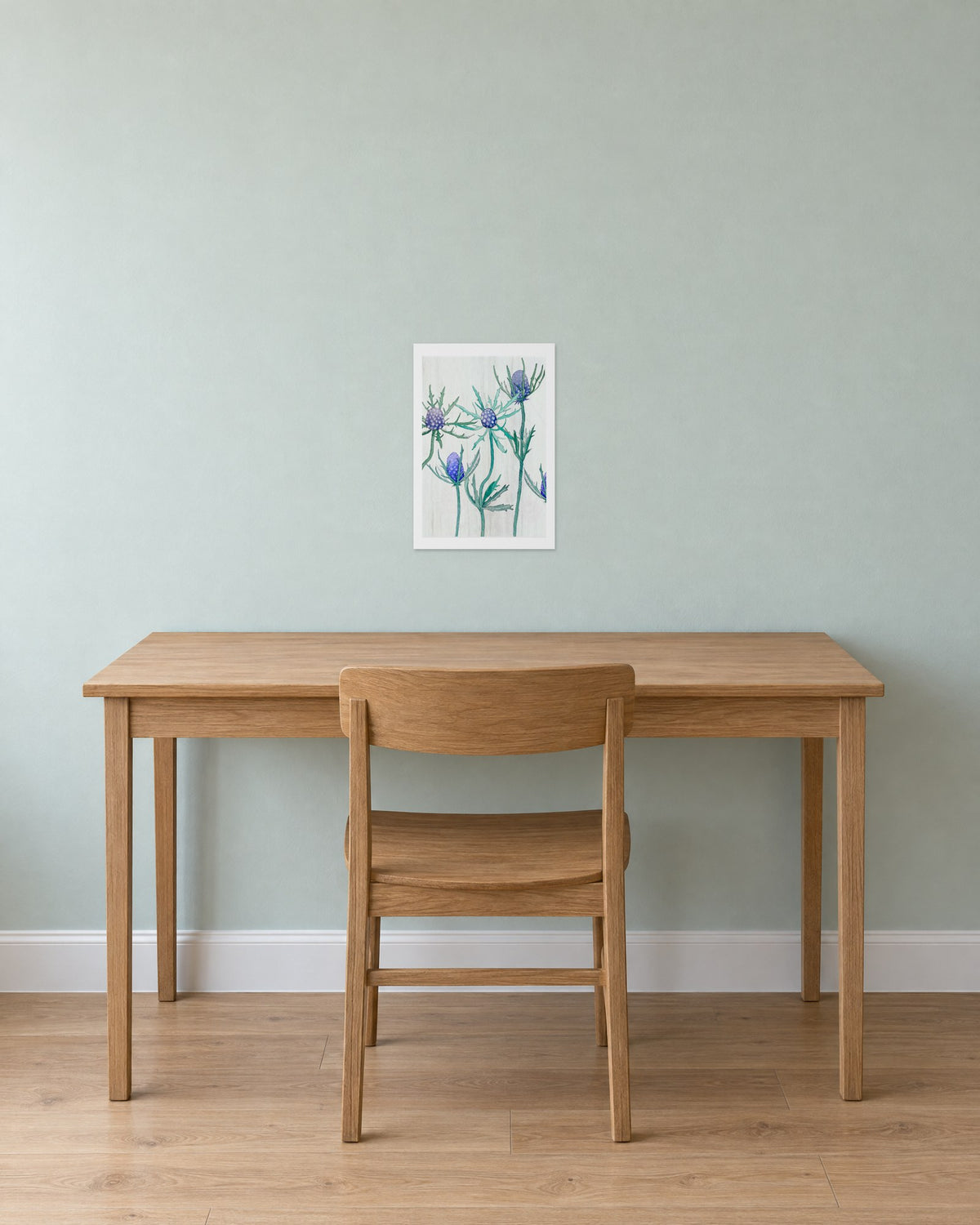 Unframed Purple Thistle on Snow print, 13 x 19 in size, on a mint-grey wall above a plain oak desk