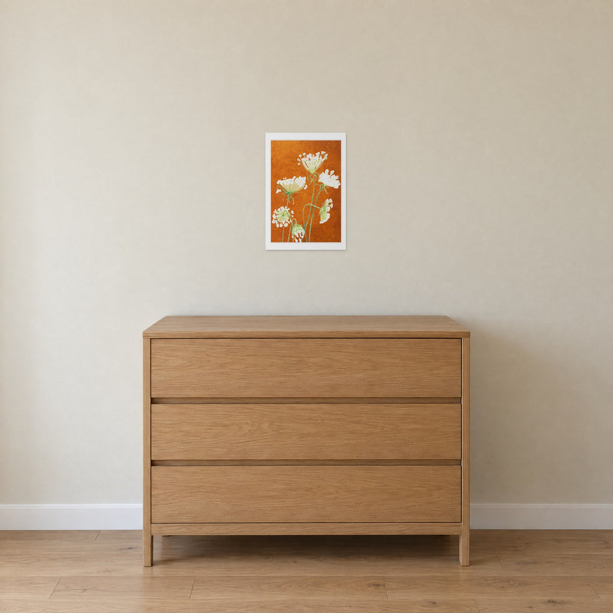 Unframed Queen Anne's Lace on Rusty Orange print, 13 x 19 in size, on a soft beige wall above an oak chest of drawers