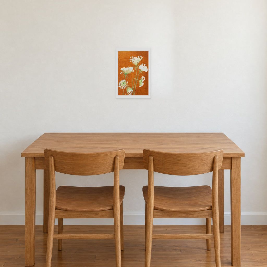 Unframed Queen Anne's Lace on Rusty Orange print, 13 x 19 in size, on a warm white wall above an oak dining table