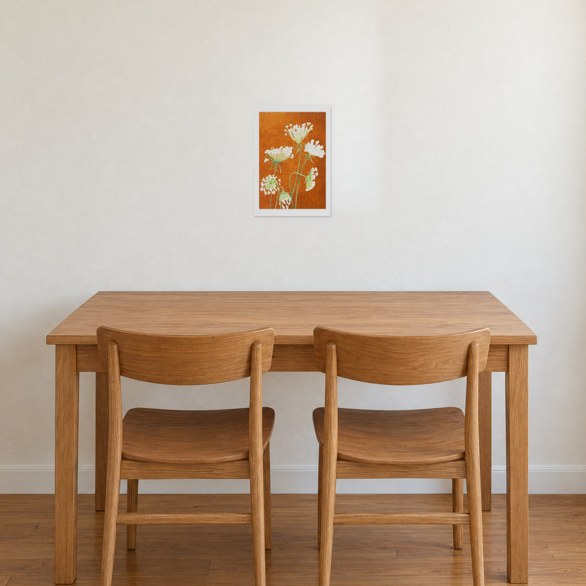 Unframed Queen Anne's Lace on Rusty Orange print, 13 x 19 in size, on a warm white wall above an oak dining table