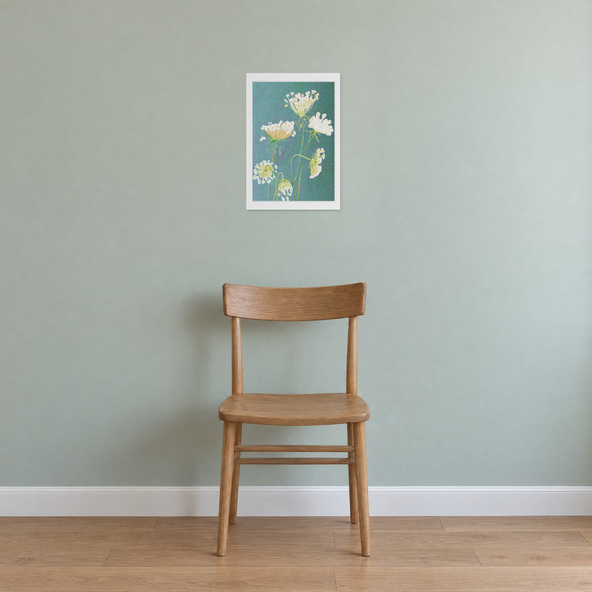 Unframed Queen Anne's Lace on Teal print, 13 x 19 in size, on a sage-grey wall above a plain wooden chair