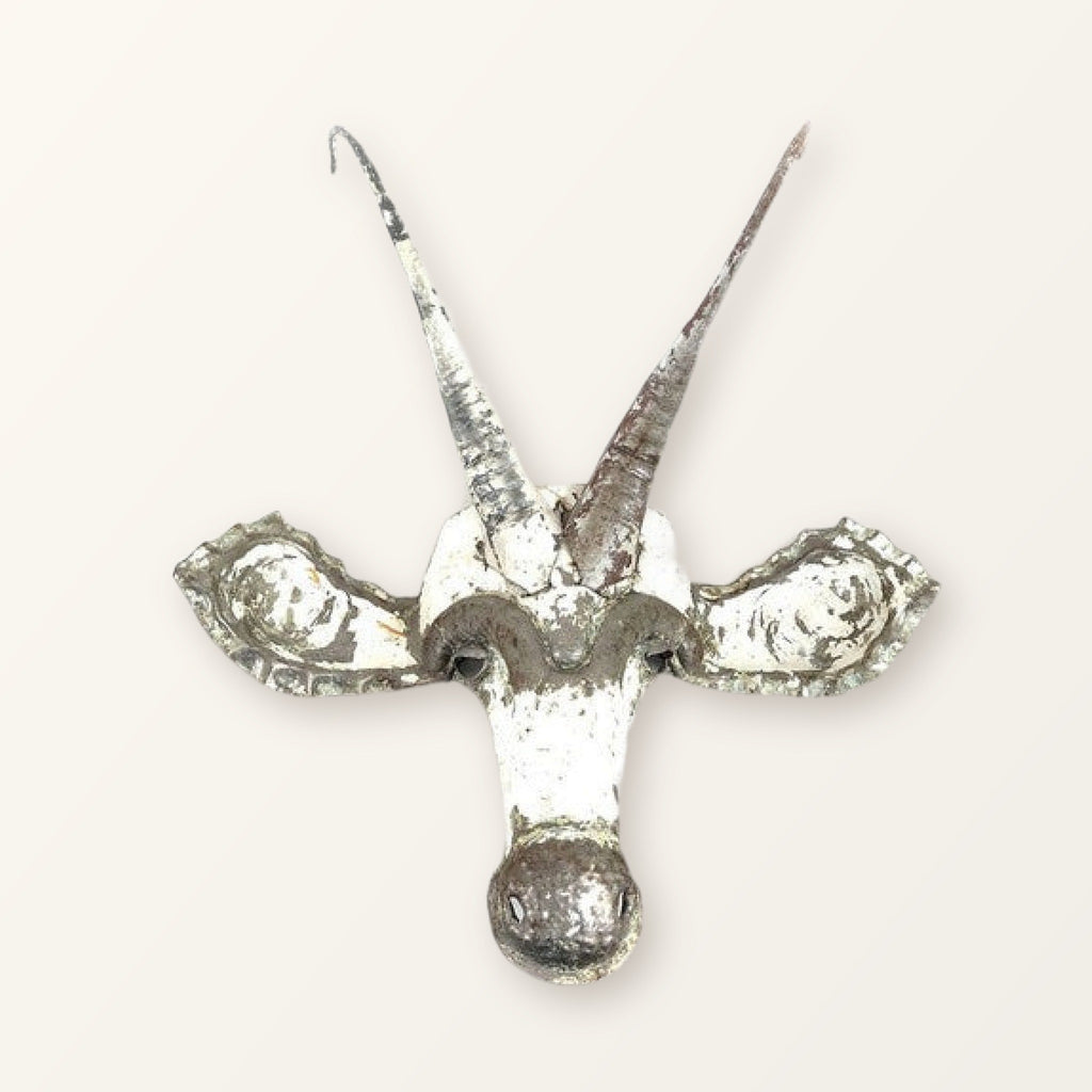 Sable antelope mask of recycled car tin, white paint worn back to bare metal, with two long horns; colour varies