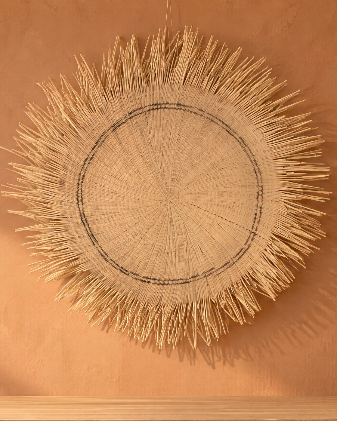 The whole Sun Circle in natural tones on a terracotta plaster wall