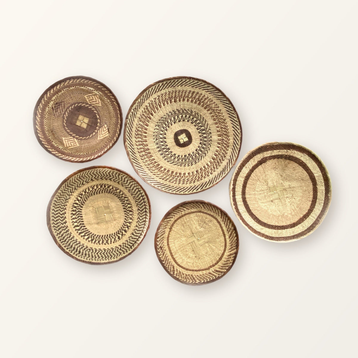 Tonga Wall Decor Basket Set of 5: five woven baskets in three sizes; patterns vary, so your set will differ