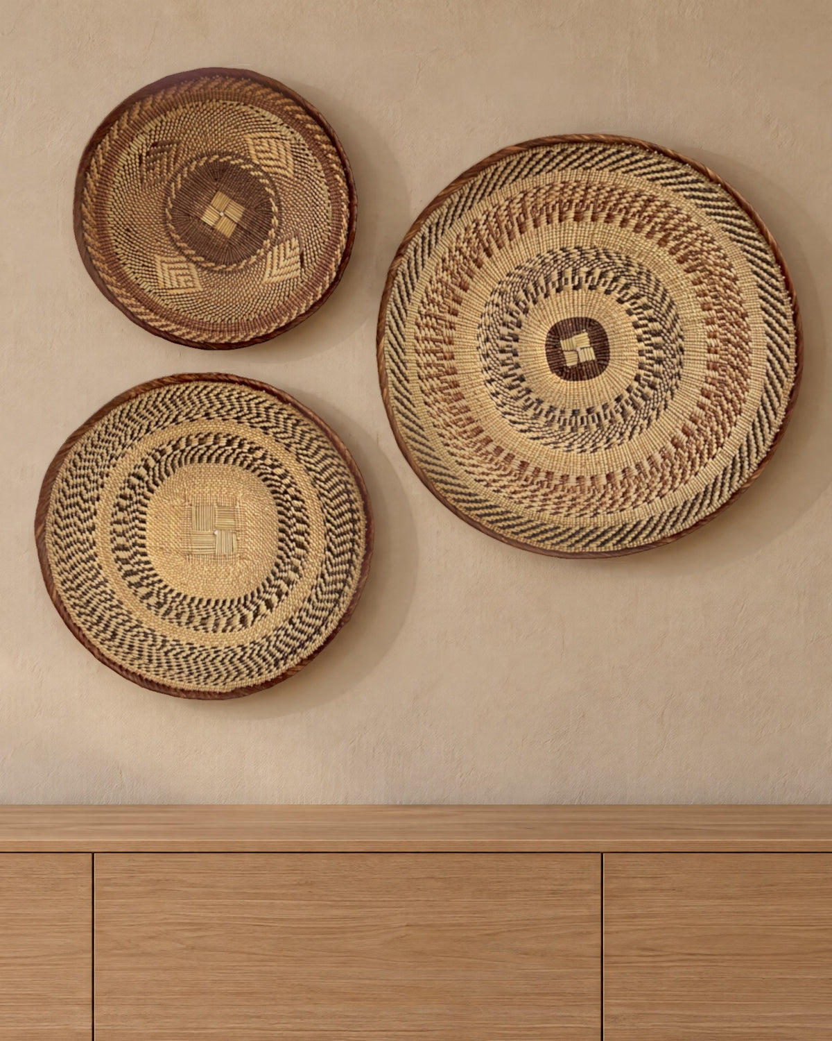 The three Tonga baskets, small, medium and large, on a warm clay plaster wall