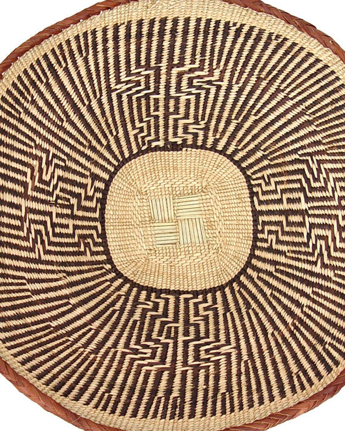 Close-up of the woven centre of a Tonga basket with dark zigzag lines (one example basket; patterns vary)