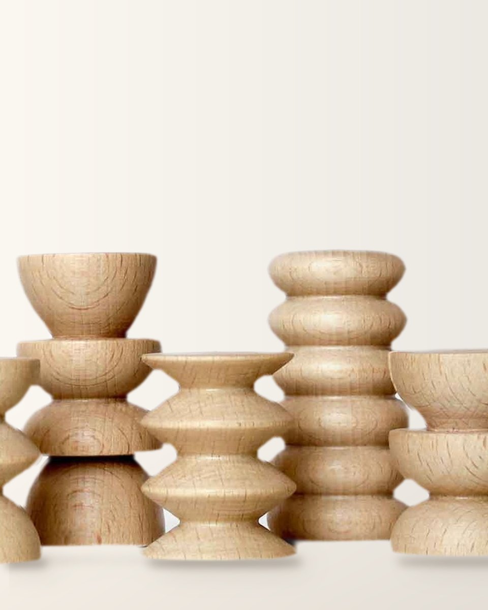 Four wooden Totem stands in different designs, side by side