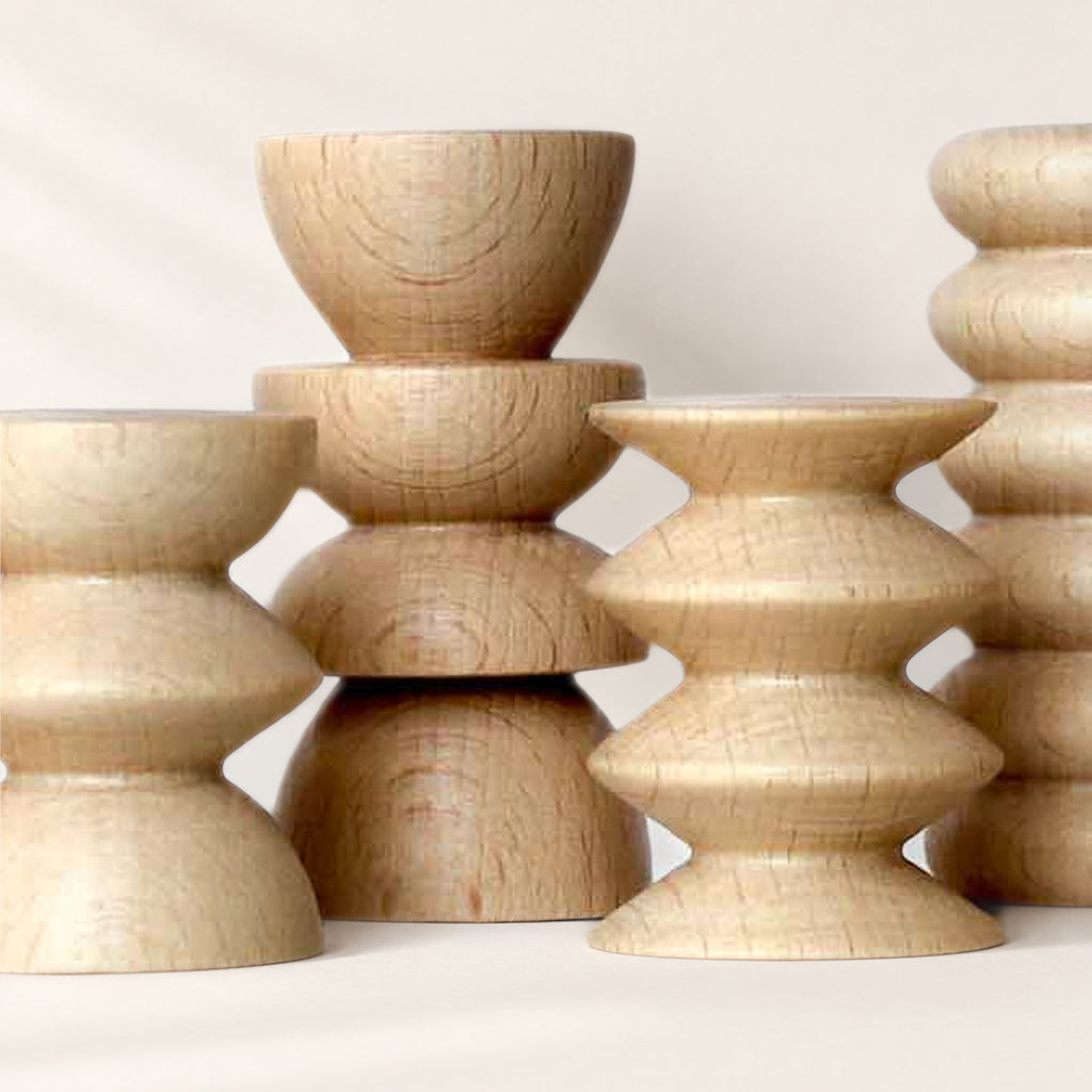Close-up of turned beech Totem stands: stacked, ridged shapes and wood grain